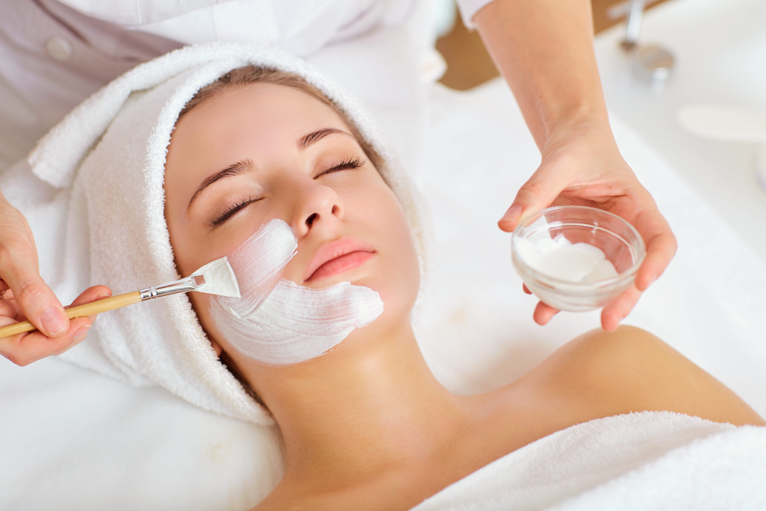 Woman with facial mask in spa beauty salon